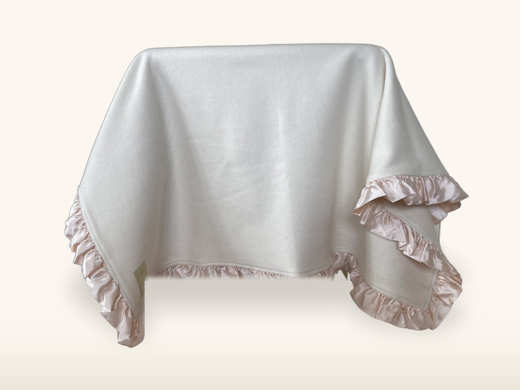Organic cotton fleece baby blanket with blush pink silk charmeuse ruffle, draped and styled