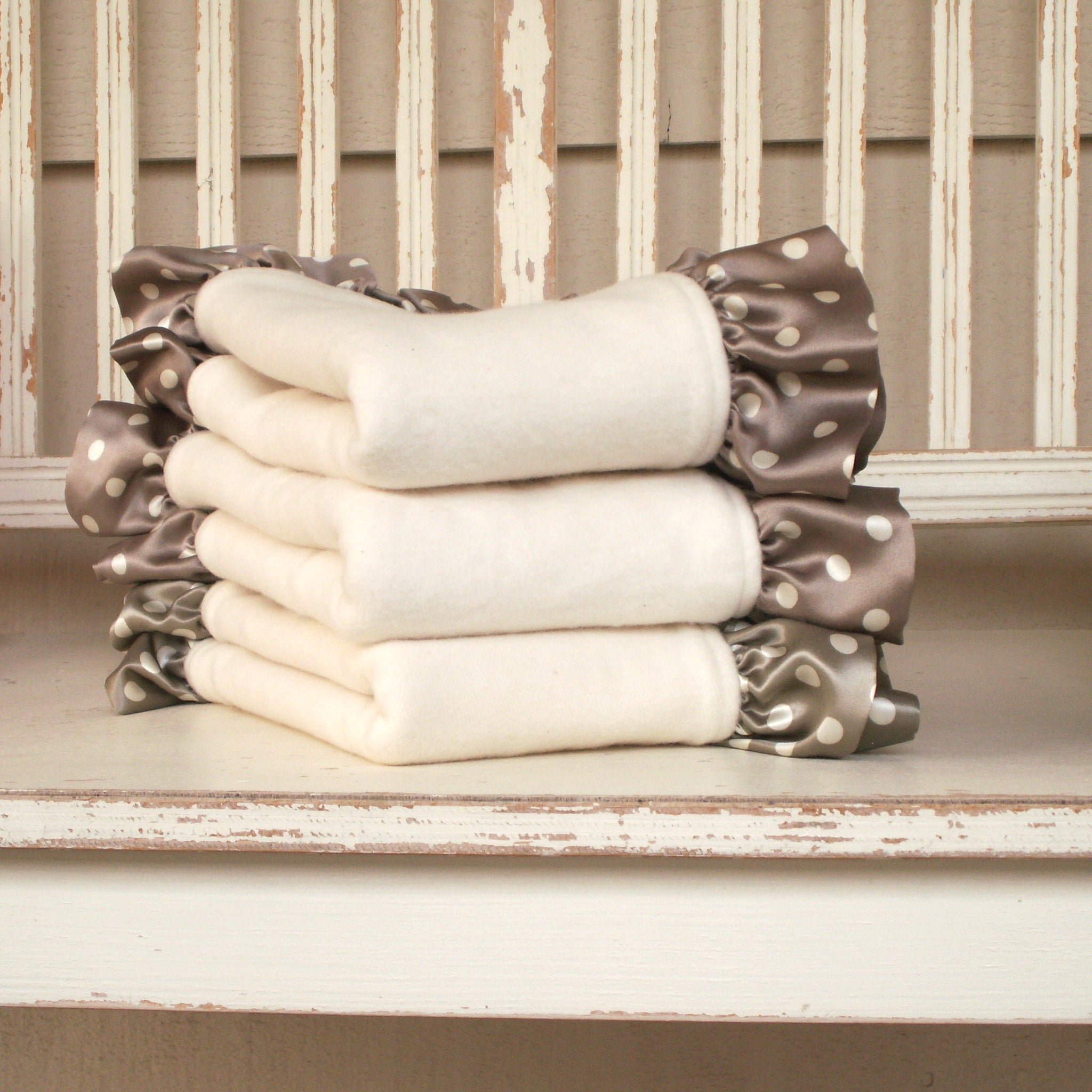 Littlest Robbie organic cotton fleece lovey blankets with silk ruffle trim, stacked