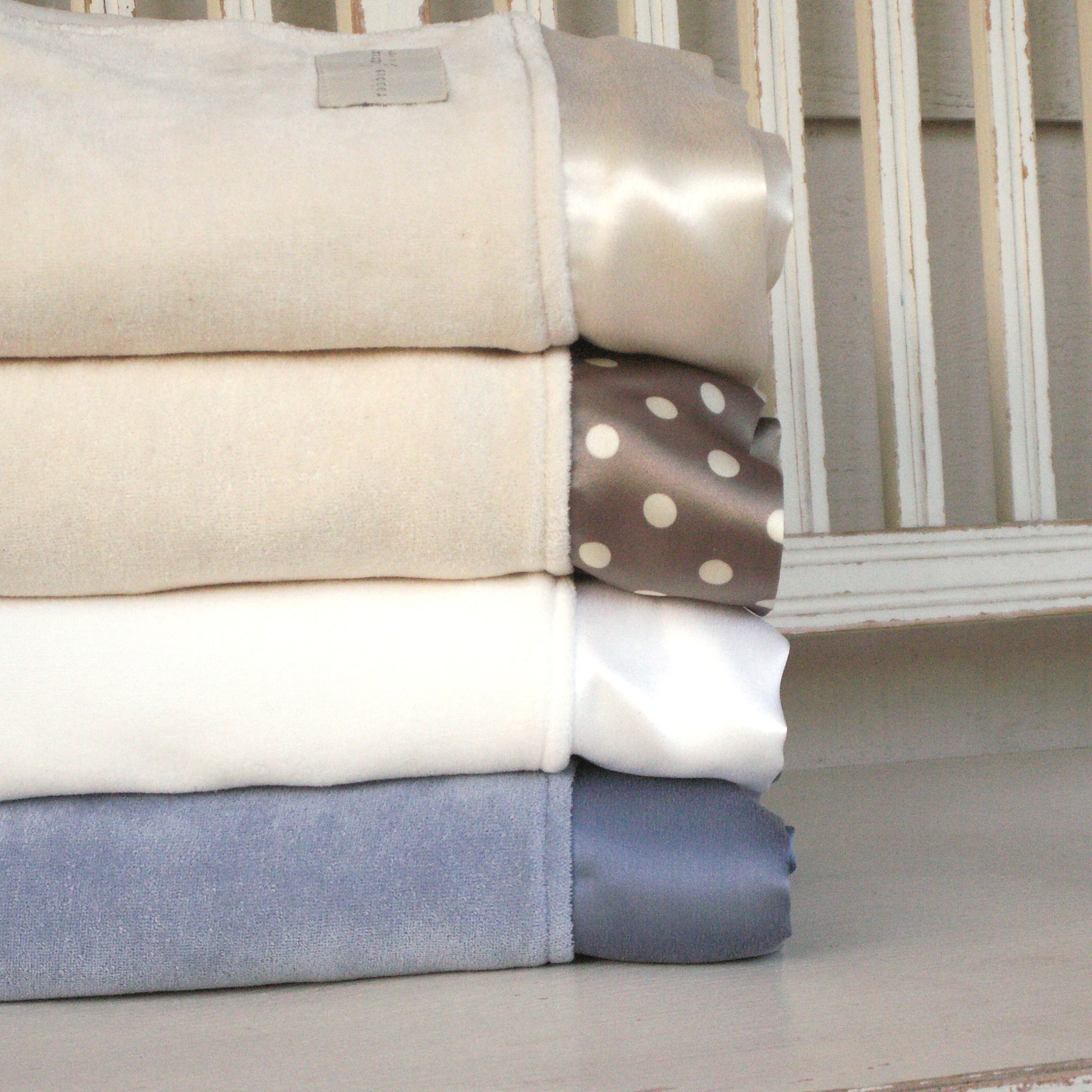 Organic cotton velour baby blankets with straight silk trim, stacked